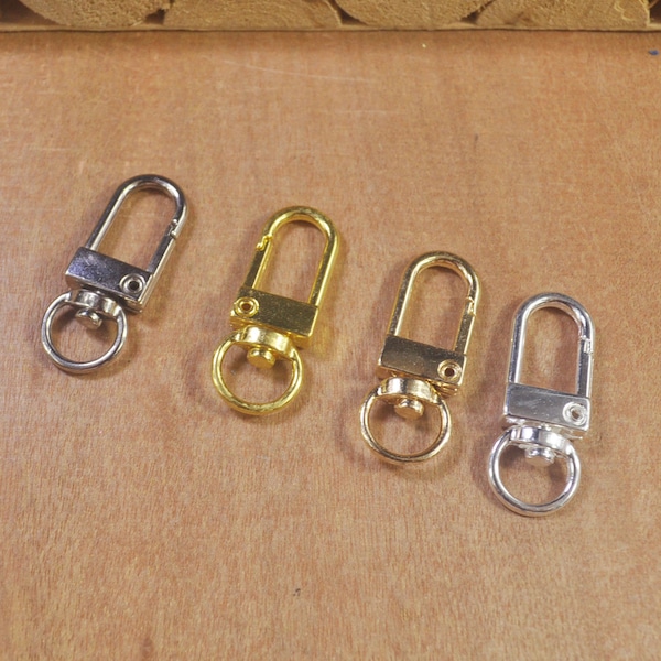 Llavero con mosquetón giratorio en blanco, oro K, oro claro o plata. Mosquetón giratorio. Conector para llaveros. Correa para bolso.