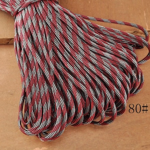 May include: A bundle of red, black, and white patterned rope. The rope is tightly wound and appears to be new. The number "80#" is printed on the lower right corner of the image.