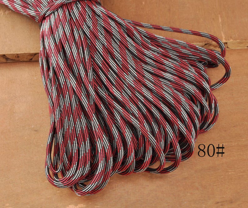May include: A bundle of red, black, and white patterned rope. The rope is tightly wound and appears to be new. The number "80#" is printed on the lower right corner of the image.