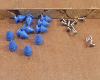 May include: A collection of blue metal pyramid-shaped studs and silver screws. The studs have a pointed tip and a flat base. The screws have a flat head and a Phillips drive.