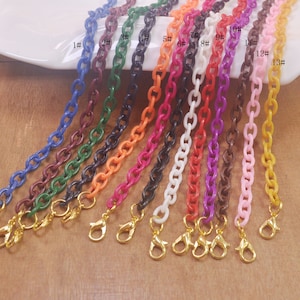 May include: Thirteen different colored plastic chains with gold clasps. The chains are numbered 1 through 13.