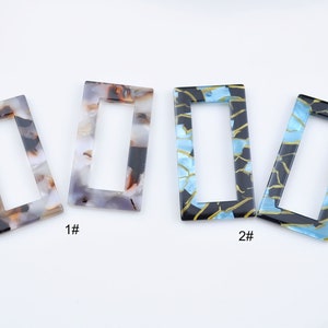 May include: Four rectangular plastic frames with different patterns. The frames are in shades of brown, black, blue, and gold. The frames are labeled 1# and 2#.