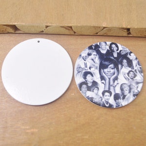 May include: Two round wooden ornaments, one blank and one with a collage of black and white photos of women. The photo ornament features a central image of a woman with her hands on her cheeks.