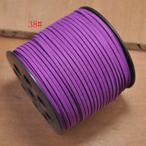 May include: A spool of purple suede cord, labeled "38#", wound around a black plastic spool with holes.
