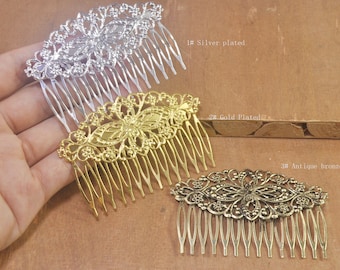 May include: Three ornate hair combs in different finishes: silver plated, gold plated, and antique bronze. Each comb features a delicate, floral design.