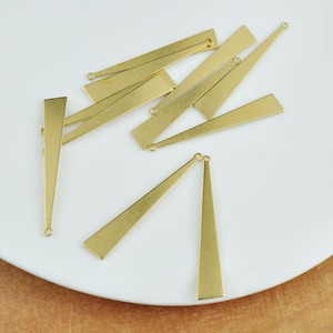 May include: A set of ten gold-toned metal triangle-shaped pendant charms with jump rings. The charms are approximately 3.8 cm long and 1.3 cm wide.