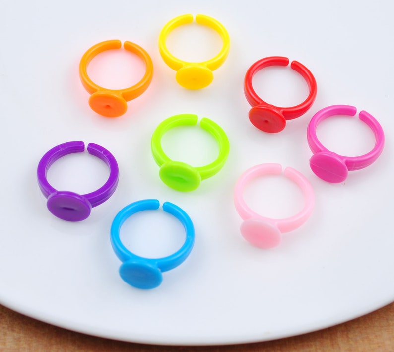 May include: Seven colorful plastic rings with a small round disc on the top of each ring. The rings are in the colors of the rainbow: red, orange, yellow, green, blue, indigo, and violet.