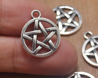 May include: Silver-toned metal charms in the shape of a five-pointed star, also known as a pentagram. The charms are circular and have a loop at the top for attaching to jewelry or other crafts.