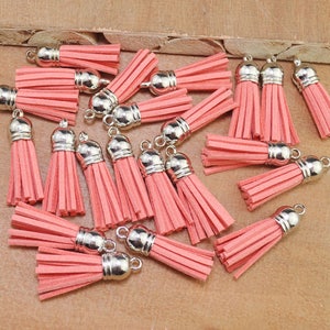 Peut inclure: Un ensemble de 20 pompons en daim rose avec des embouts en métal argenté. Les pompons mesurent environ 3,8 cm de long et sont parfaits pour ajouter une touche de fantaisie à l'artisanat, aux bijoux et à la décoration intérieure.