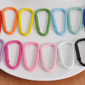 May include: Assortment of 12 colorful metal keychains in various colors, including red, orange, yellow, green, blue, purple, pink, and black.