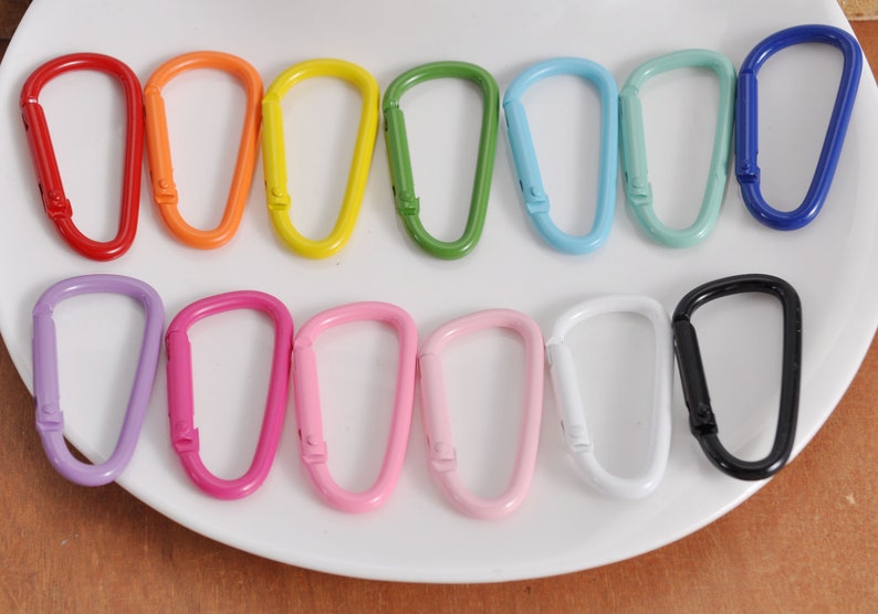 May include: Assortment of 12 colorful metal keychains in various colors, including red, orange, yellow, green, blue, purple, pink, and black.