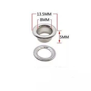 Może przedstawiać: Srebrne metalowe oczka o średnicy zewnętrznej 13,5 mm, średnicy wewnętrznej 8 mm i wysokości 5 mm. Oczka są używane do rękodzieła, odzieży i innych projekt&oacute;w.