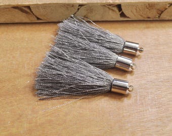 May include: Three gray tassel trim with silver metal caps and loops.