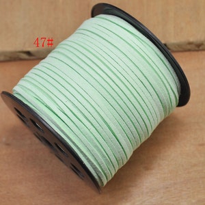 May include: A spool of light green leather cord, wound around a black plastic spool. The spool is labeled "47#"