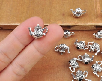 May include: Silver teapot charms with intricate details. The charms are perfect for adding a touch of vintage charm to jewelry projects.