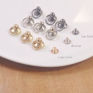 May include: Assortment of metal ring and screw closures in gun black, rhodium, and light gold finishes. These closures are ideal for leather goods, bags, and other craft projects.