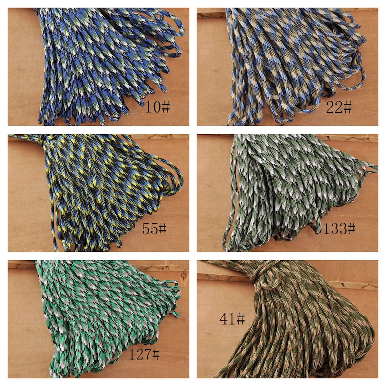 May include: A collection of colorful paracord bundles, each with a unique pattern and color scheme. The cords are labeled with numbers, showcasing a variety of options for crafting and outdoor projects. Colors include blue, green, yellow, and brown.