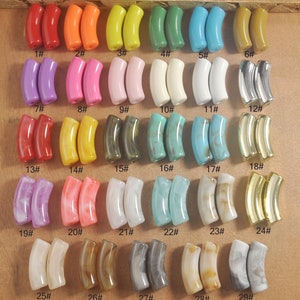 May include: Twenty-nine pairs of colorful, patterned, and textured plastic beads in the shape of a half-circle. The beads are arranged in rows of two, numbered 1 through 29.