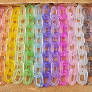 以下が含まれることがあります： 虹色の半透明プラスチックチェーンの詰め合わせ。各チェーンは赤から紫まで異なる色をしています。チェーンは、左側に赤いチェーン、右側に紫色のチェーンが並ぶように並んでいます。