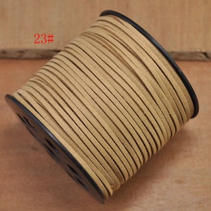 May include: A spool of light brown suede cord, wrapped around a black plastic spool. The spool is labeled "23#"