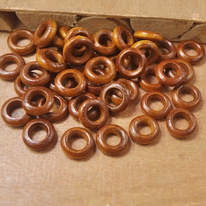 May include: A pile of brown wooden rings, perfect for crafting projects.