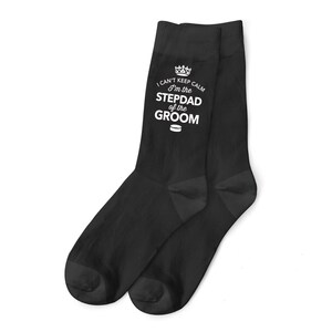 May include: Black socks with a white design that says "I can't keep calm I'm the stepdad of the groom" with a crown above the text and a hockey puck below the text.