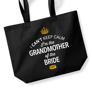 May include: Black tote bag with a white graphic that says "I can't keep calm I'm the grandmother of the bride" with a gold crown and hockey puck.