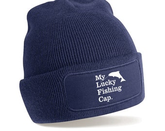 May include: A navy blue beanie with a white patch that says "My Lucky Fishing Cap." The patch features a white silhouette of a fish with a fishing line.