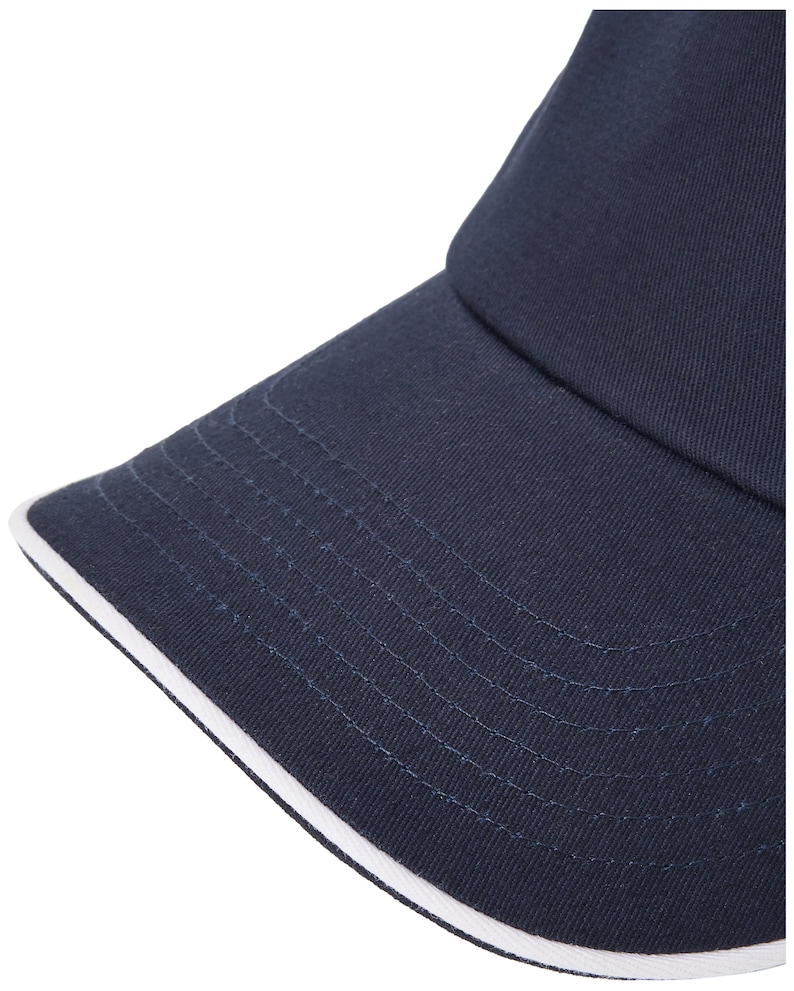 May include: A navy blue baseball cap with a white trim around the brim.