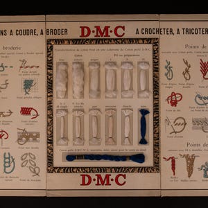 May include: A vintage DMC embroidery chart with instructions for different stitches, including embroidery, crochet, knitting, and darning. The chart features a variety of colors of DMC cotton thread.