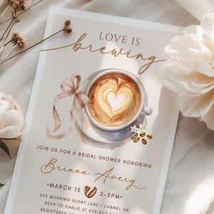 May include: A bridal shower invitation with the text "Love is Brewing" and a coffee cup design. The invitation includes details for Briana Avery's shower, with a date, time, and location. The design features a heart-shaped latte art.