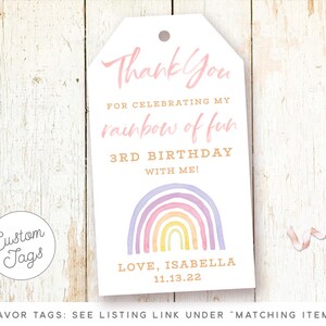 May include: A white thank you tag with a rainbow design and the text "Thank You for celebrating my rainbow of fun 3rd Birthday with me! Love, Isabella 11.13.22".