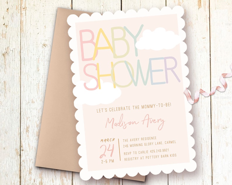 Op de afbeelding: Een roze babyborrel uitnodiging met een gegolfde rand. De uitnodiging heeft een kleurrijke "BABY SHOWER" afbeelding met wolken. De tekst luidt "Let's celebrate the mommy-to-be! Madison Avery March 24 2-5 PM The Avery Residence 245 Morning Glory Lane, Carmel RSVP to Carlie 425.243.9921 Registry at Pottery Barn Kids"