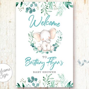 May include: Welcome sign for a baby shower with a cute cartoon elephant and green foliage. The sign says "Welcome to Brittany Flynn's Baby Shower".