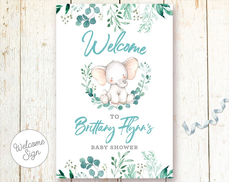 May include: Welcome sign for a baby shower with a cute cartoon elephant and green foliage. The sign says "Welcome to Brittany Flynn's Baby Shower".