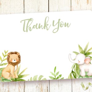 May include: A white thank you card with green foliage and a lion and elephant illustration. The text "Thank You" is written in green.