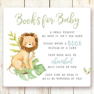 May include: A white card with green text that reads "Books for Baby". A small lion illustration is on the left side of the card. The text on the card reads "A small request we hope it isn't too hard. Please bring a book instead of a card. Your book will be cherished well-loved or new. Each time we read it, we'll be reminded of you!"