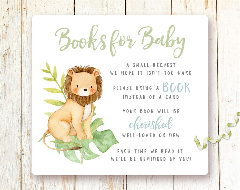 May include: A white card with green text that reads "Books for Baby". A small lion illustration is on the left side of the card. The text on the card reads "A small request we hope it isn't too hard. Please bring a book instead of a card. Your book will be cherished well-loved or new. Each time we read it, we'll be reminded of you!"