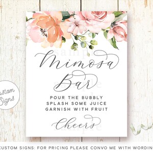May include: A printable sign with a floral design in shades of pink and peach. The sign says "Mimosa Bar" and includes instructions to "Pour the bubbly, splash some juice, garnish with fruit, Cheers".