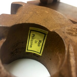 May include: A wooden ring with a yellow label that reads "Made in Philippines".
