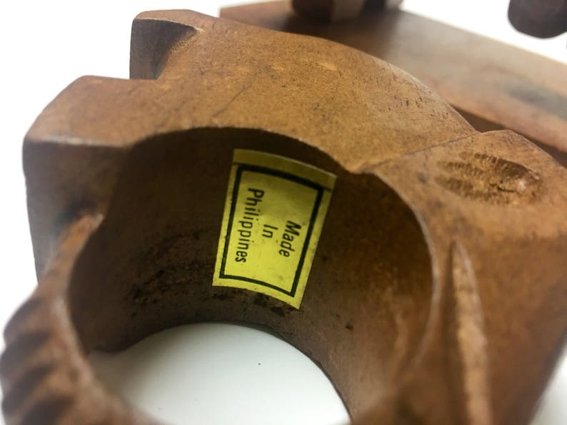 May include: A wooden ring with a yellow label that reads "Made in Philippines".