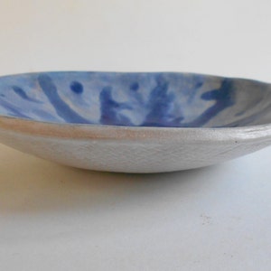 Handmade blue white pottery bowl with organic shape and textured underside image 4