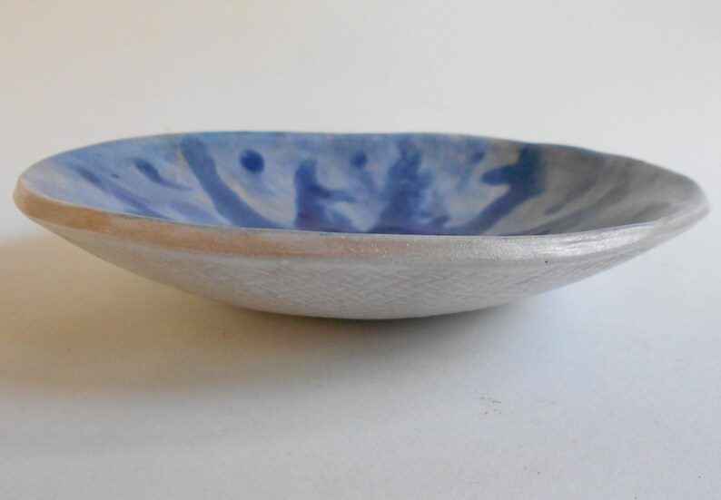 Handmade blue white pottery bowl with organic shape and textured underside image 4