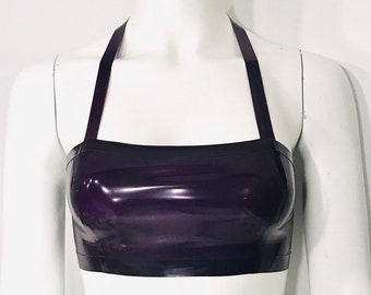 May include: A purple halter top made of shiny latex. The top has a simple, straight neckline and a cropped fit.