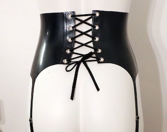 May include: Black leather garter belt with a lace-up back and silver eyelets. The garter belt has two adjustable straps on each side.
