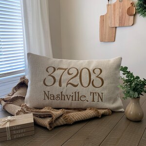 Add a personal touch to your living space with this custom-made zip code throw pillow. Featuring machine embroidery with the city, state, and zip code of your choice, this pillow is an ideal gift or home accent.