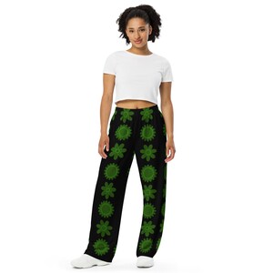 Unisex pants Black with wide leg and side pockets, green flowers