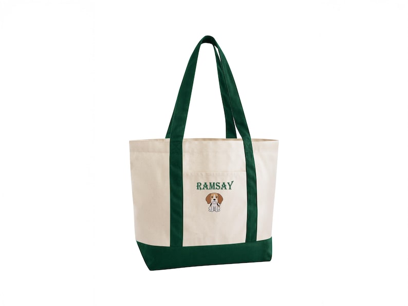 May include: Cream-colored canvas tote bag with dark green accents. The bag features a dark green base, trim, and handles. The word "RAMSAY" is embroidered in green above a cartoon beagle illustration.