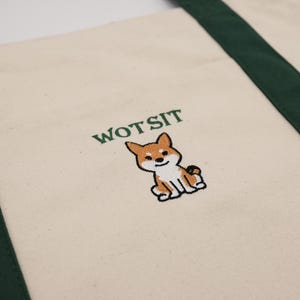 Photo of the a green piped dog bag with Wotsit