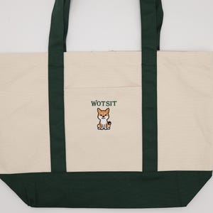 Full Photo of the a green piped dog bag with Wotsit